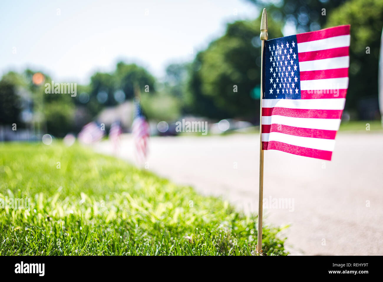 American Flag decorating a yard in a neighborhood on the 4th of July Stock Photo