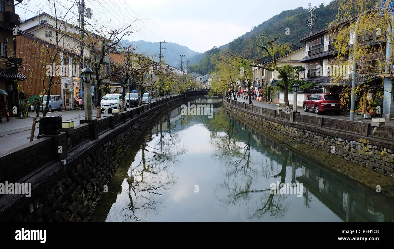 Canal in Kinosaki hot spring town, Japan. Along both sides of the canal are shops, ryokan and houses. Stock Photo