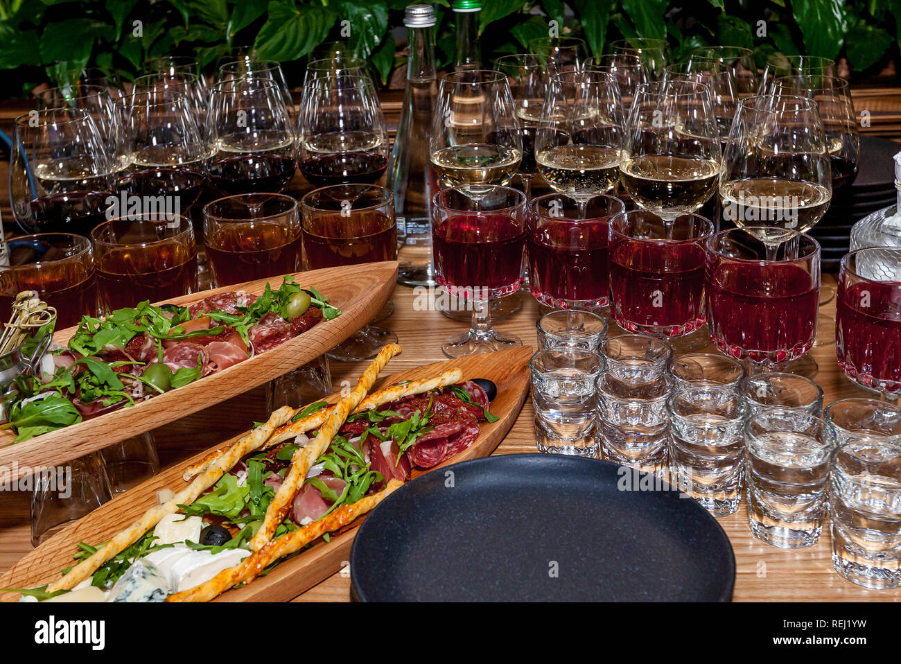 Various snacks and alcohol in glasses on a celebratory table for a