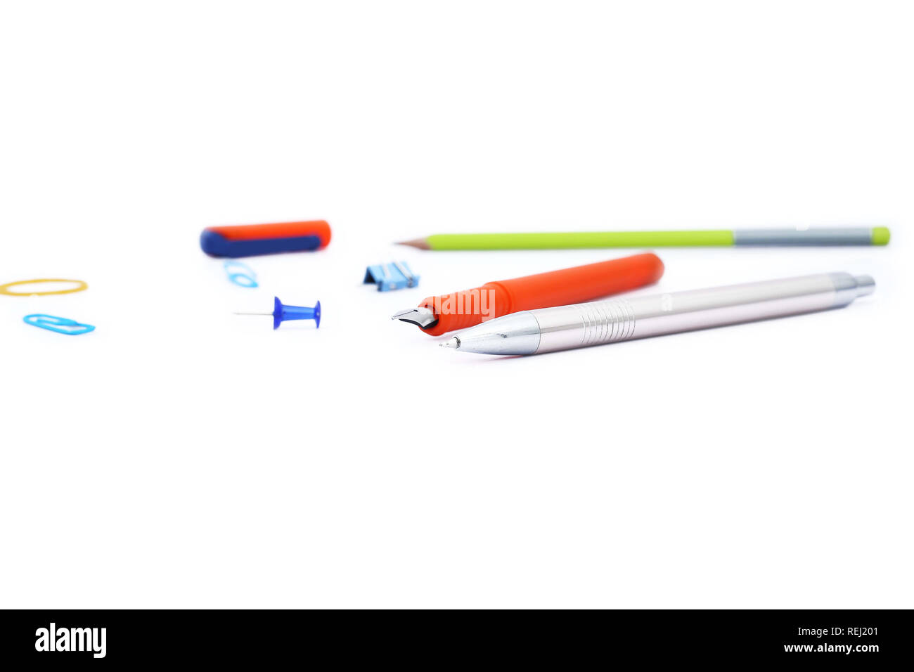 Picture of fountain pen, ball pen, pencil and paper clip. Isolated on
