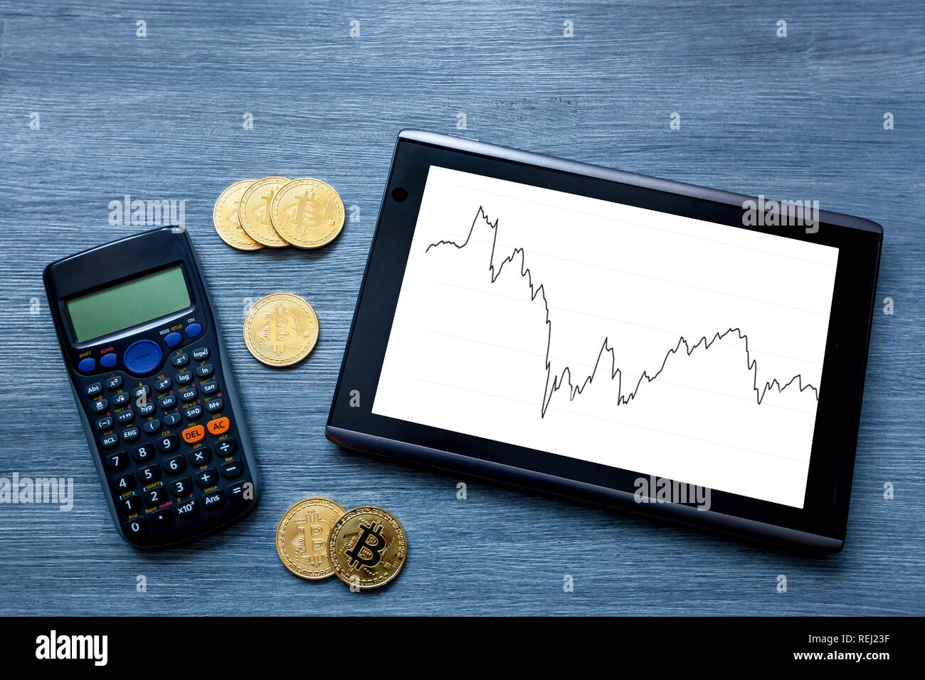 Cryptocurrency Gold bitcoin, coins, bitcoin, tablet and calculator on  wooden background, bitcoin mining concept Stock Photo - Alamy