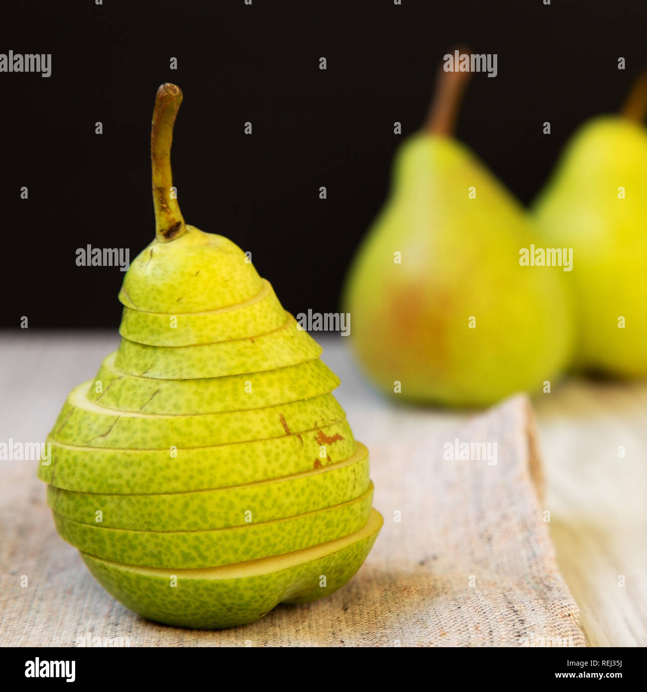 Sliced fresh pear on cloth, side view. Close-up. Stock Photo