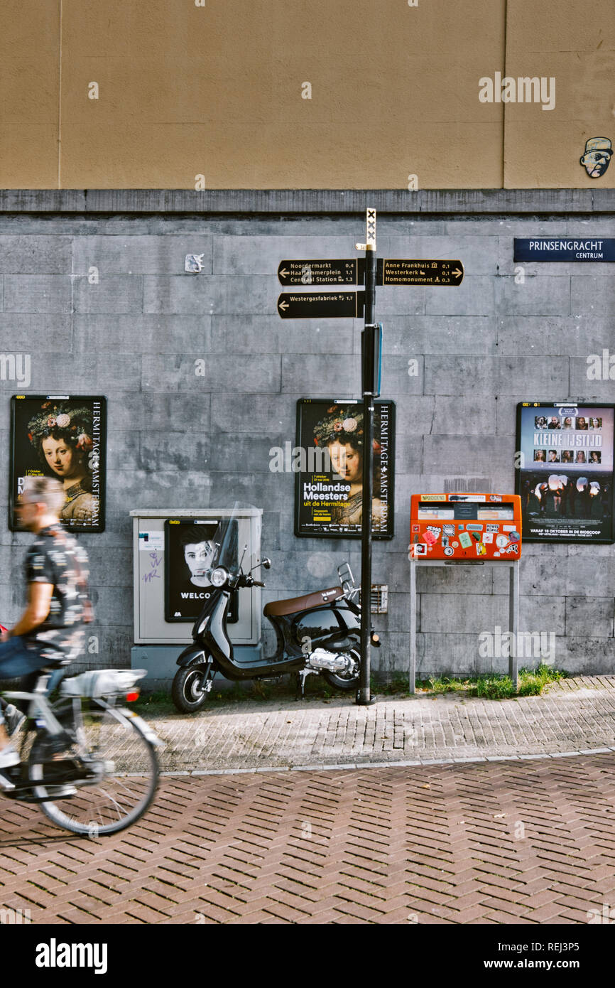 Direction signs to tourist attractions and cyclist, Prinsengracht, Amsterdam, Netherlands, Europe Stock Photo