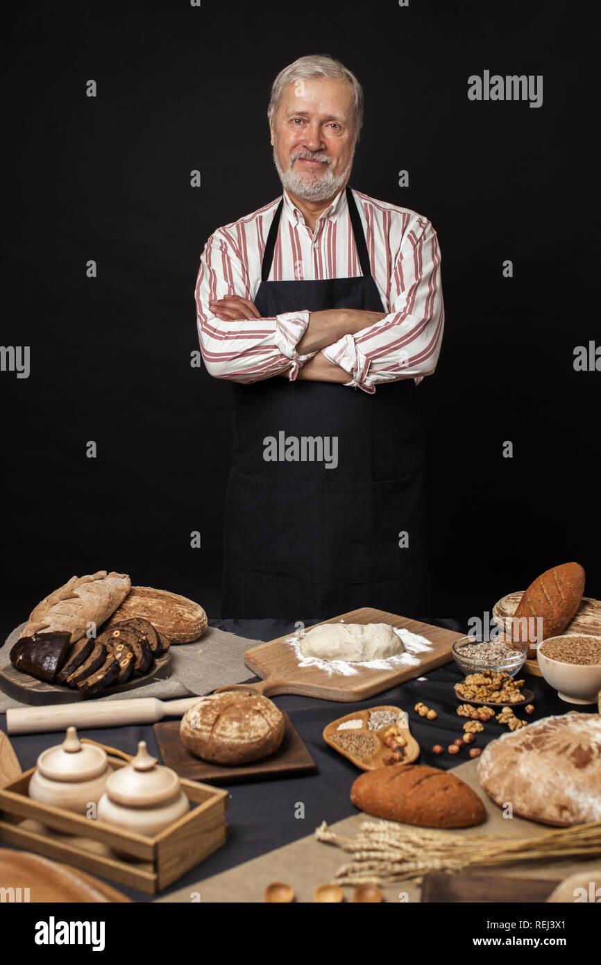 Male senior chef isolated on black background Stock Photo