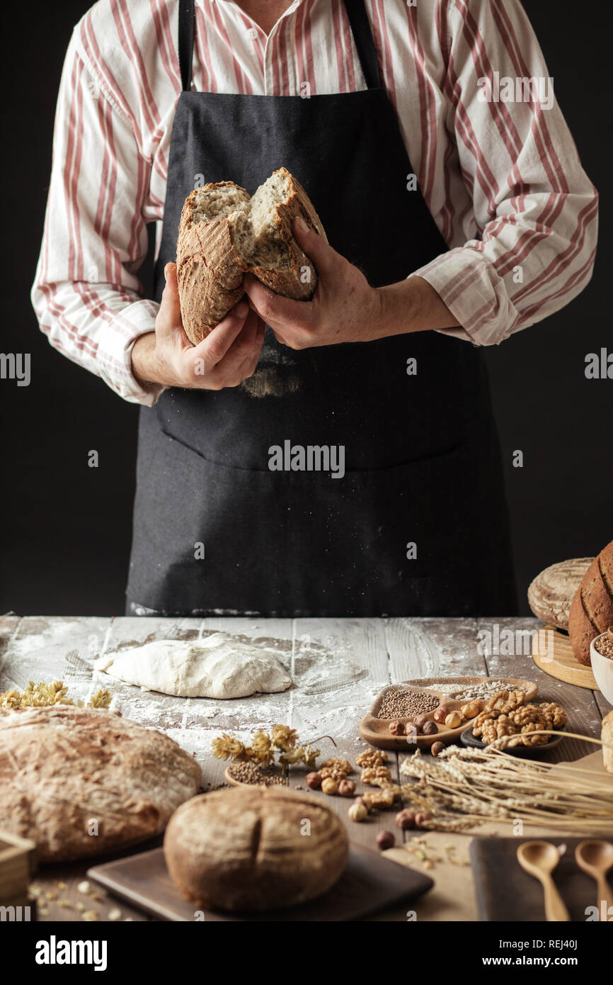 Chef Breaking Freshly Baked Sourdough Bread Stock Photo - Alamy