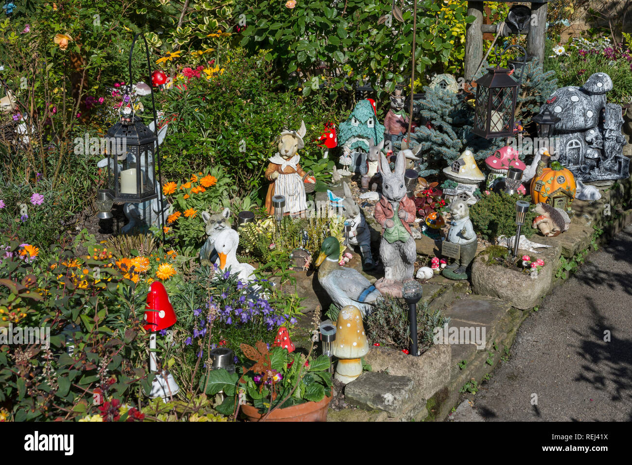 Garden full of colourful ornaments in the village of Eyam, Derbyshire, England.  The garden raises money for charity. Stock Photo
