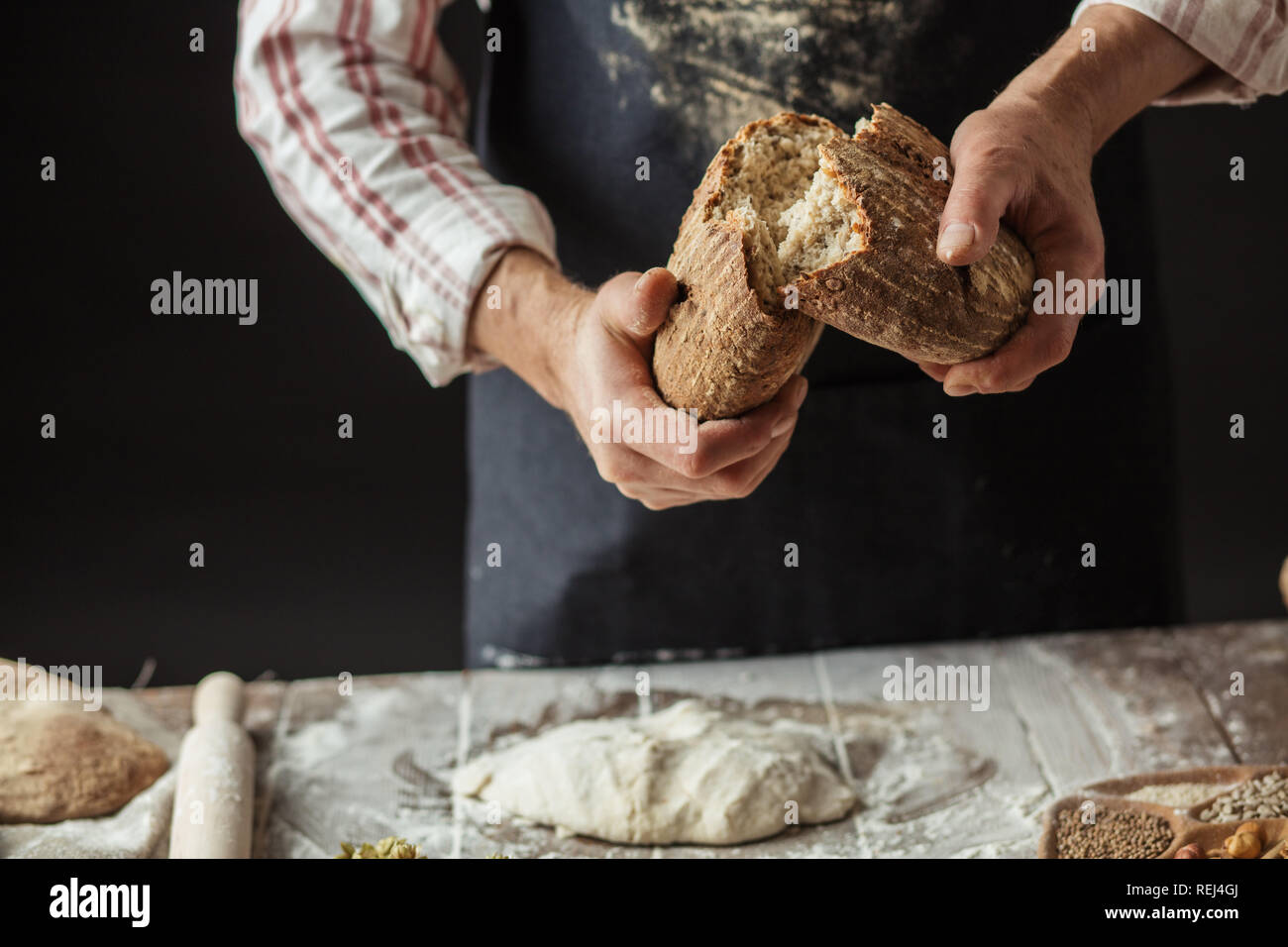 Baker hands breaking homemade bread hi-res stock photography and images ...