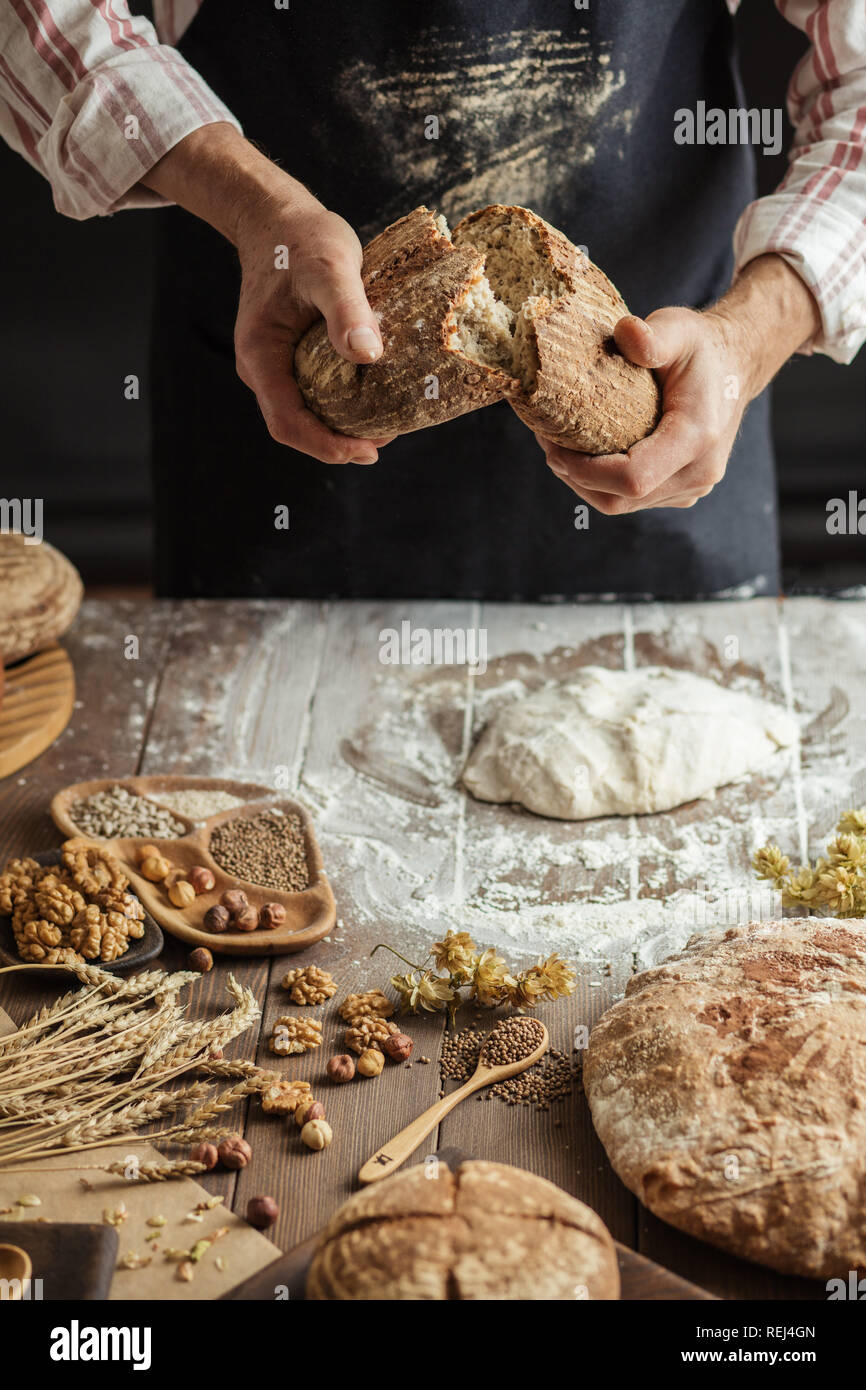 Chef Breaking Freshly Baked Sourdough Bread Stock Photo - Alamy