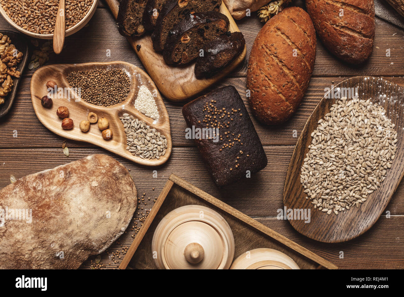 Whole grain multigrain bread, whole and sliced, contains seeds isolated on black Stock Photo