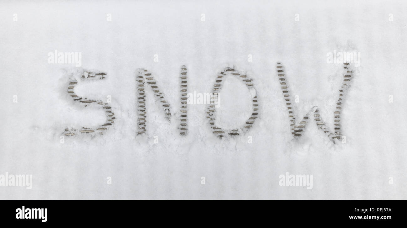 handwriting text letters snow in winter landscape in the white snow Stock Photo