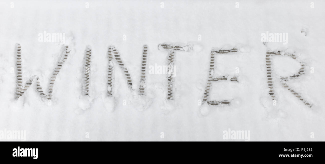 handwriting text letters winter in winter landscape in the white snow Stock Photo