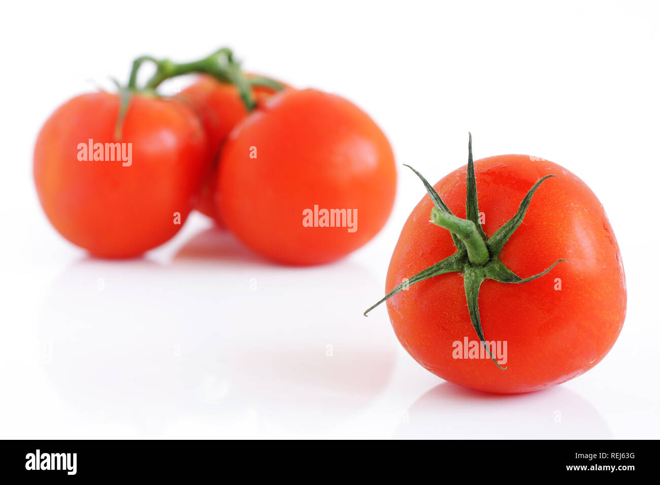 Fresh tomatoes, isolated on white Stock Photo