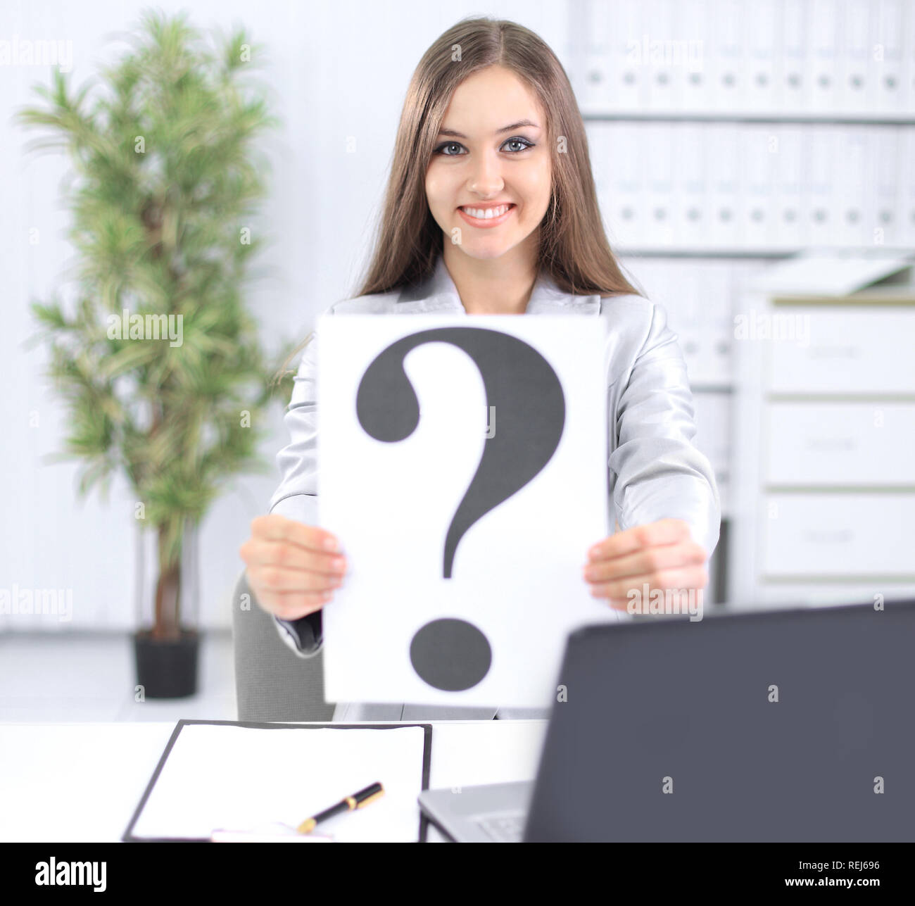 young business woman showing a question mark Stock Photo - Alamy