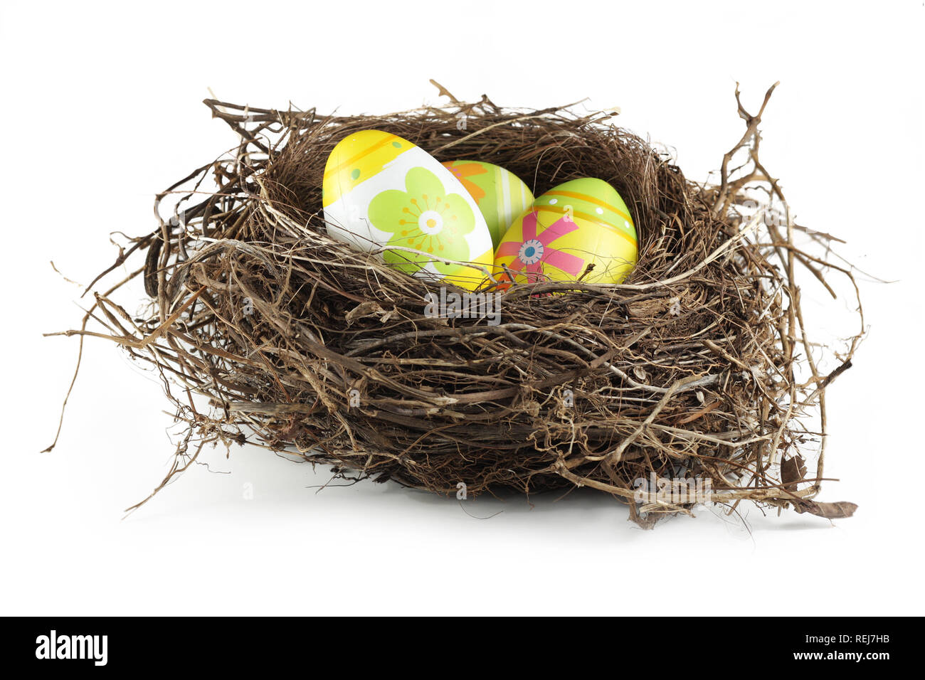 Easter eggs in real bird nest, isolated on white Stock Photo - Alamy