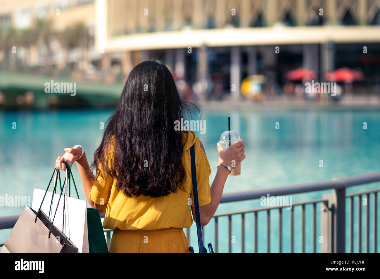 Girl with shopping bags in front of a mall outdoors Stock Photo