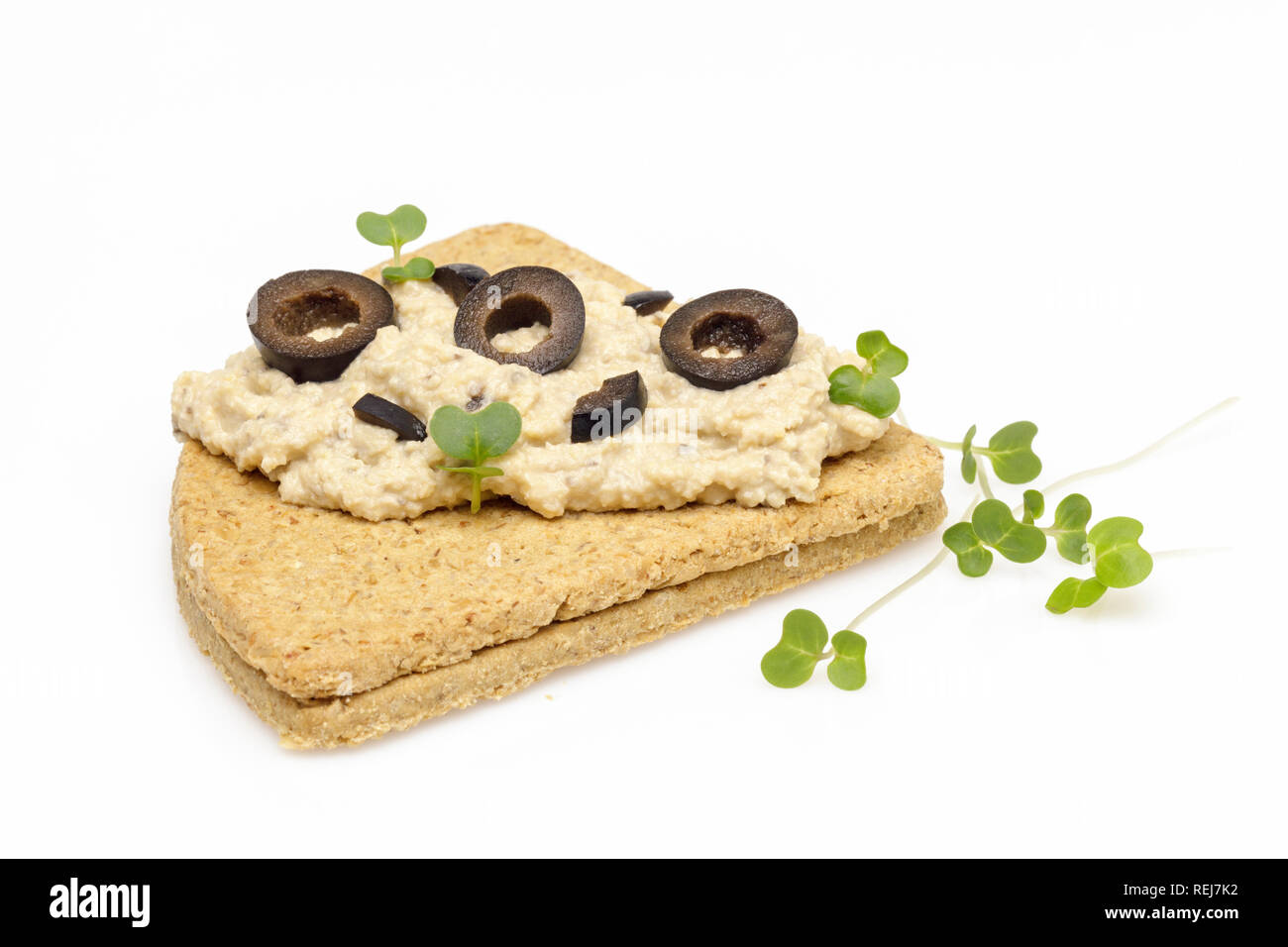 Triangle oatcakes with hummus and cress close up Stock Photo