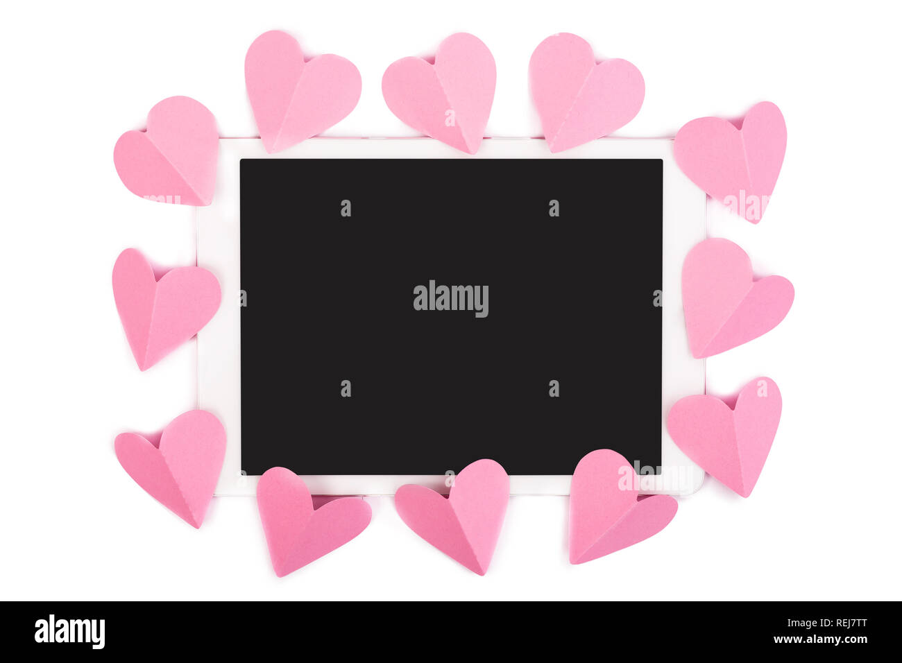 Pink paper hearts framing touchpad with blank screen isolated on white Stock Photo