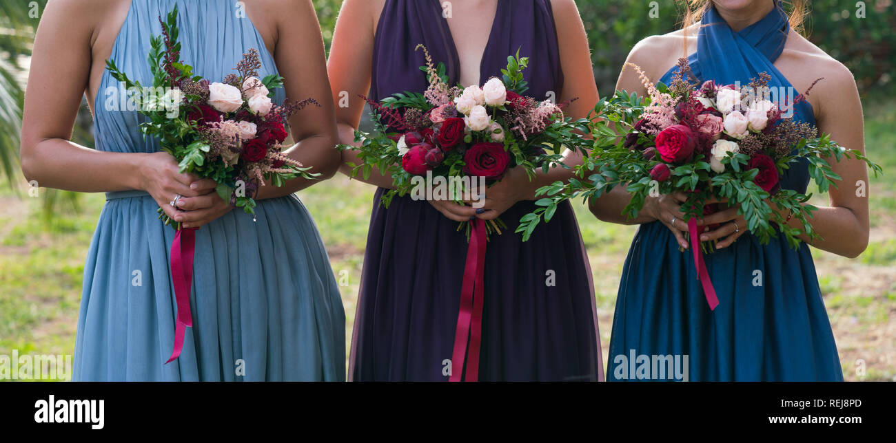 bridesmaids holding flowers in their hands Stock Photo Alamy