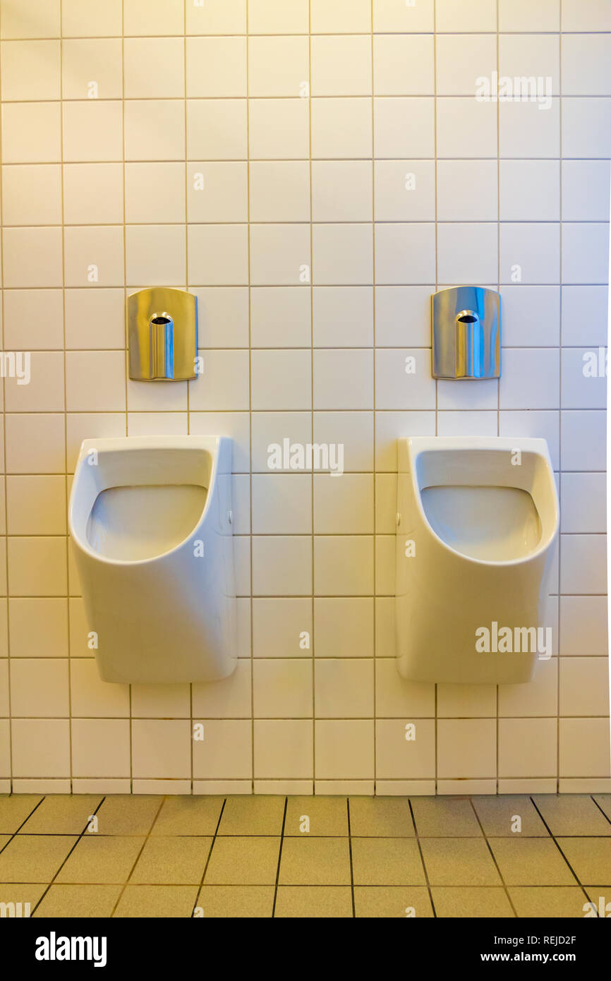 A urinal is a sanitary plumbing fixture for urination only Stock Photo