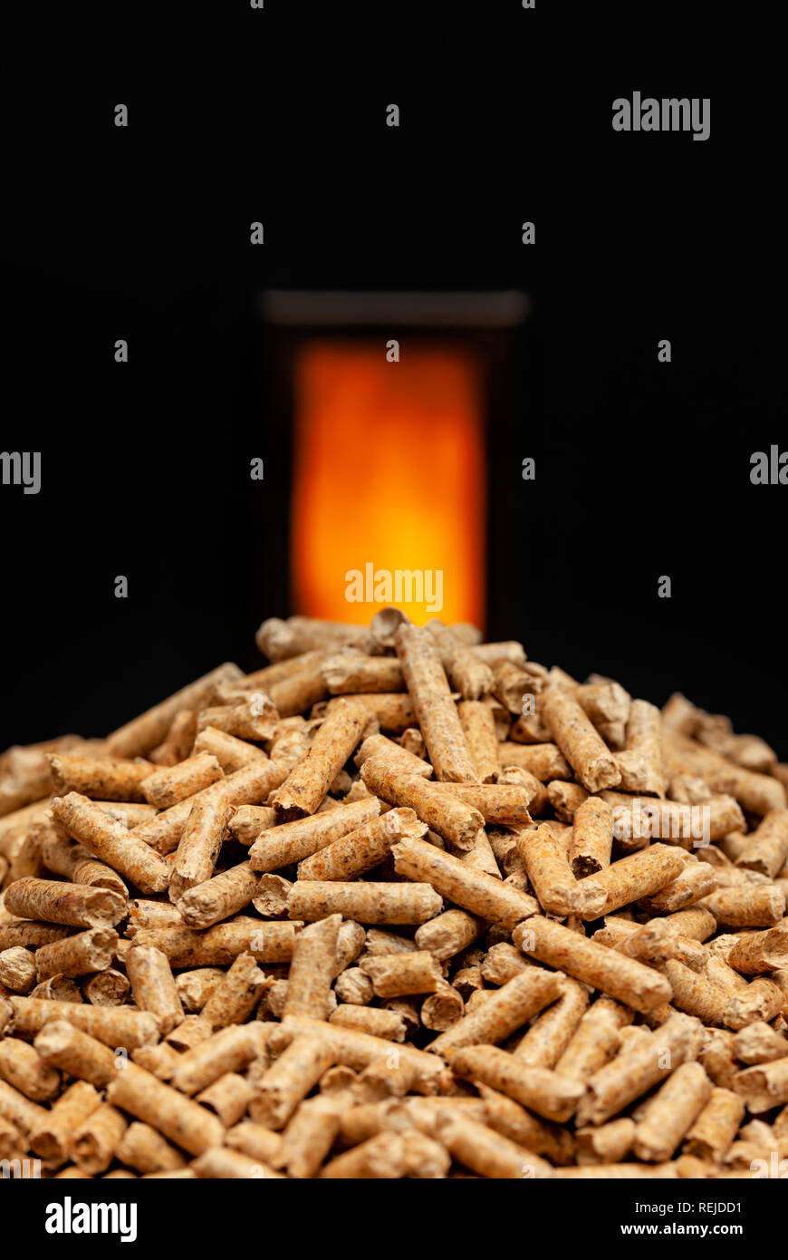 Wood pellets with combustion chamber in the background. Stock Photo