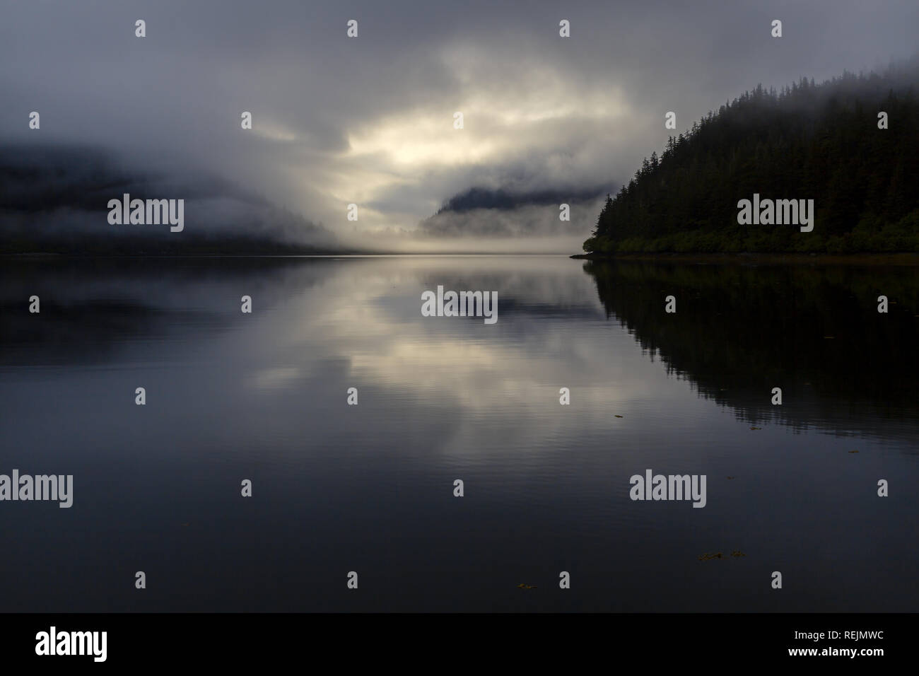 An evening fog rolls in to Fox Farm Bay, Elrington Island, Prince William Sound, Alaska Stock Photo