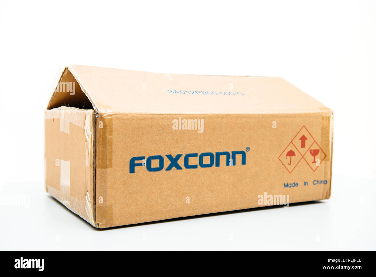 LONDON, UNITED KINGDOM - AUG 23, 2018: Side view of Foxconn cardboard delivery box with logotype on against white background containing spare parts for computers laptop and technology parts Stock Photo