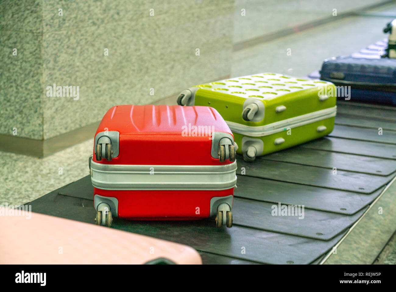 Colorful travel suitcase at international airport Stock Photo Alamy