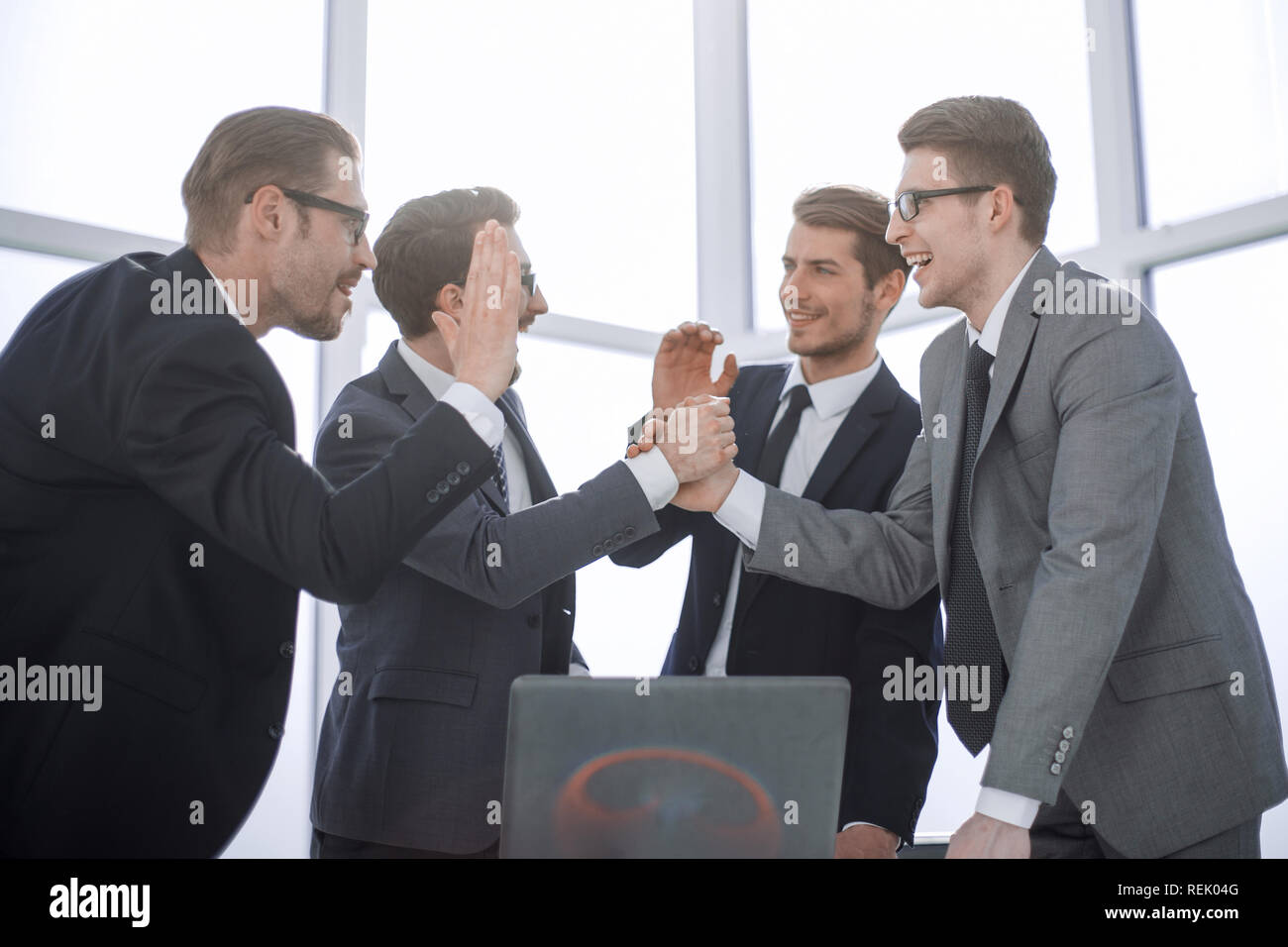 happy employees giving each other a high five Stock Photo - Alamy