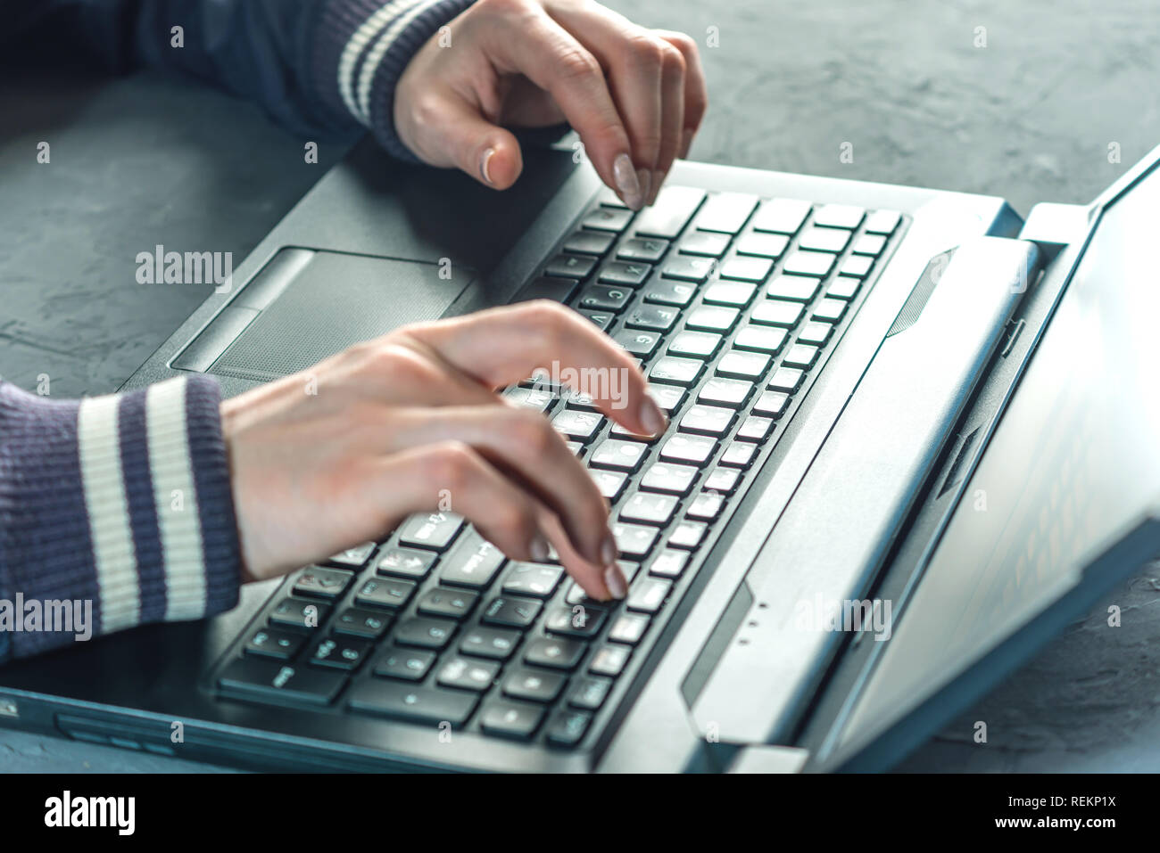 Hacker the programmer is typing on the keyboard of the laptop to hack the system. Stealing personal data. Creation and infection of malicious virus. Stock Photo