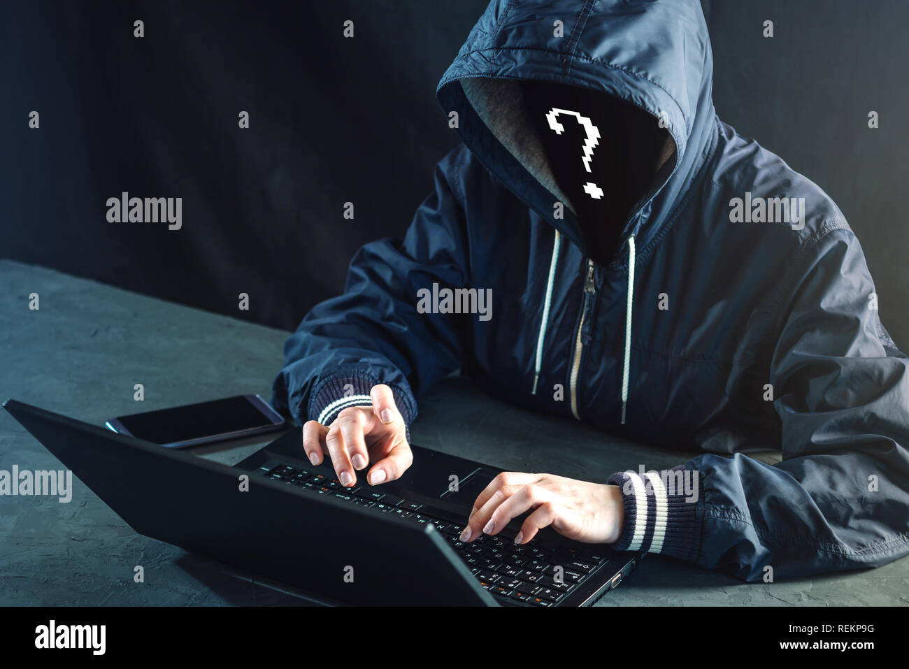 Anonymous hacker programmer uses a laptop to hack the system. Stealing personal data. Creation and infection of malicious virus. The concept of cyber  Stock Photo