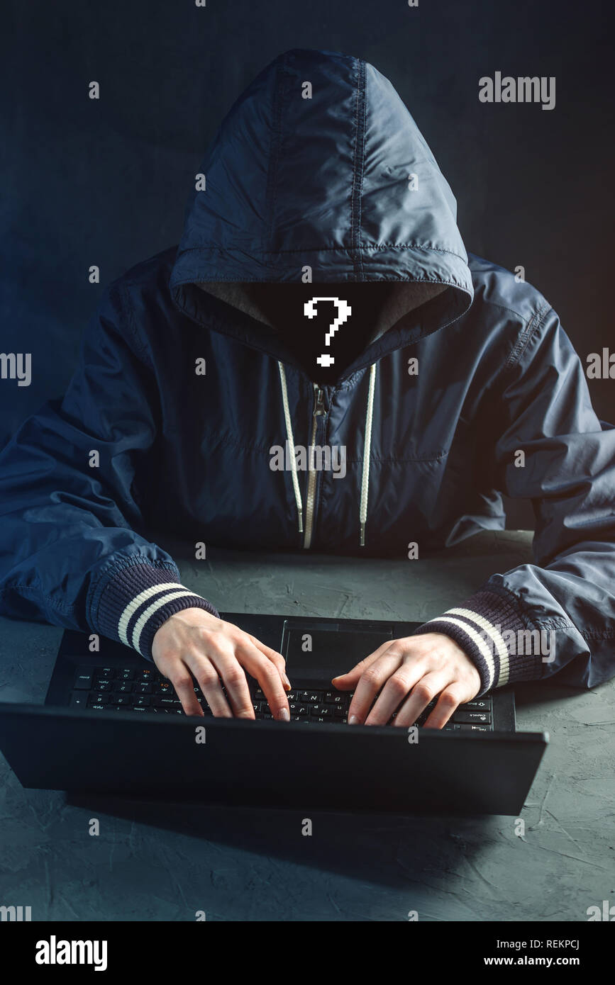 Anonymous hacker programmer uses a laptop to hack the system. Stealing ...