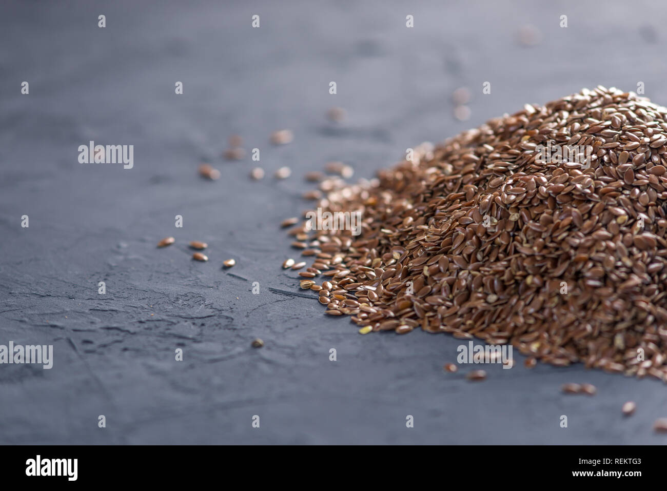 Flax seeds in a pile on a dark background. The concept healthy diet