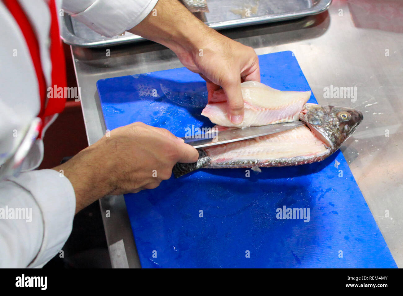 chef cooking raw fish on kitchen, Process of cooking fish Stock Photo