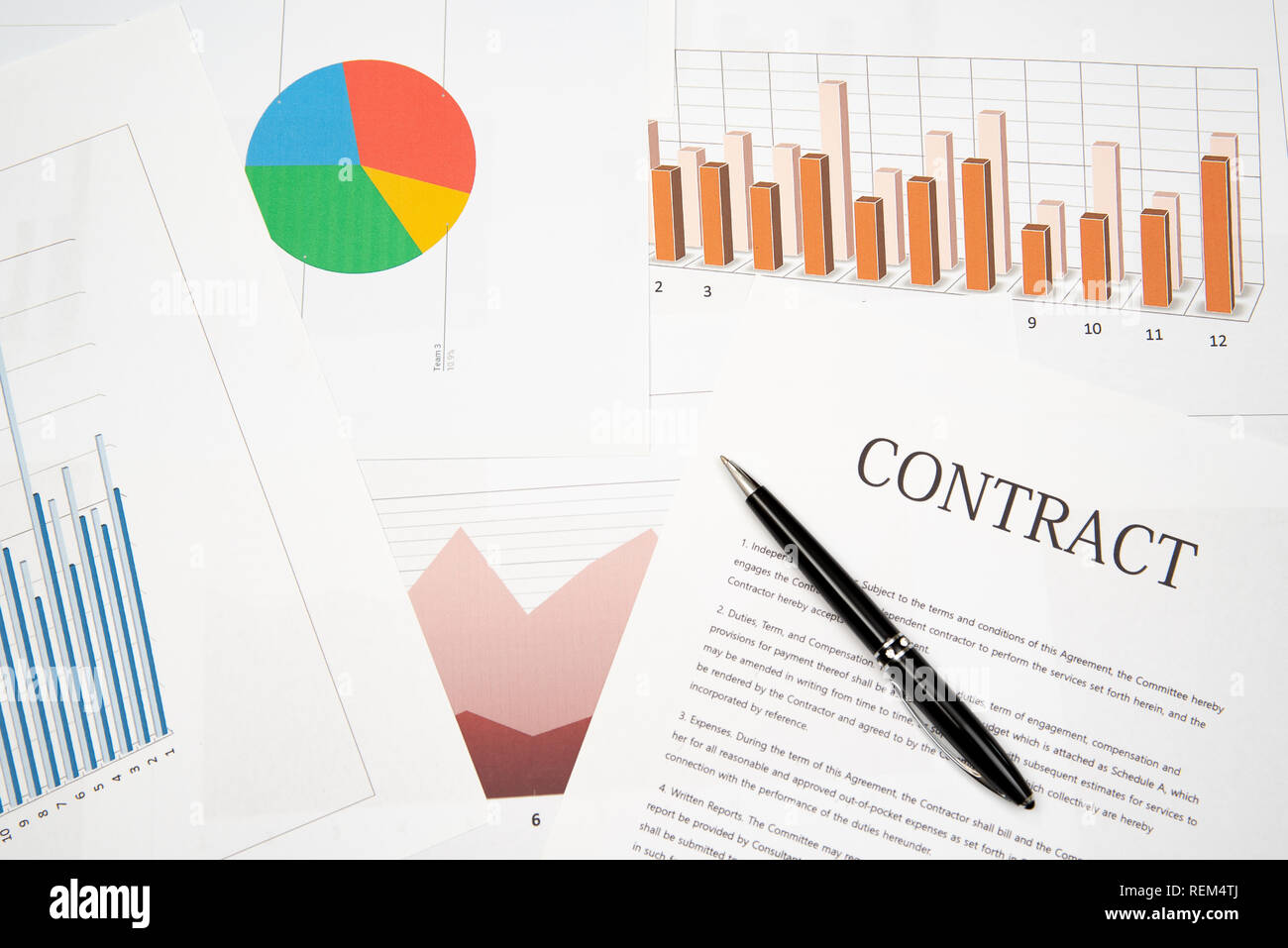 Contracts, charts, and graphs on the desk. Business desk concept Stock ...