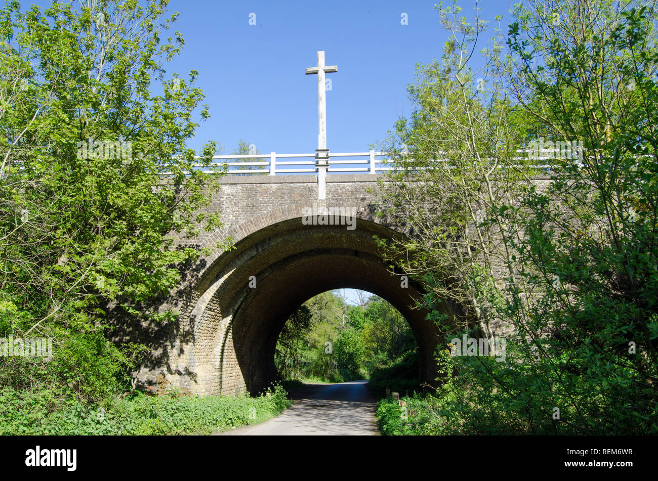The Pilgrims' Way footpath passing underneath the old A3 viaduct and an arch designed by the famous architect Edwin Lutyens.  Crosses on top of the vi Stock Photo