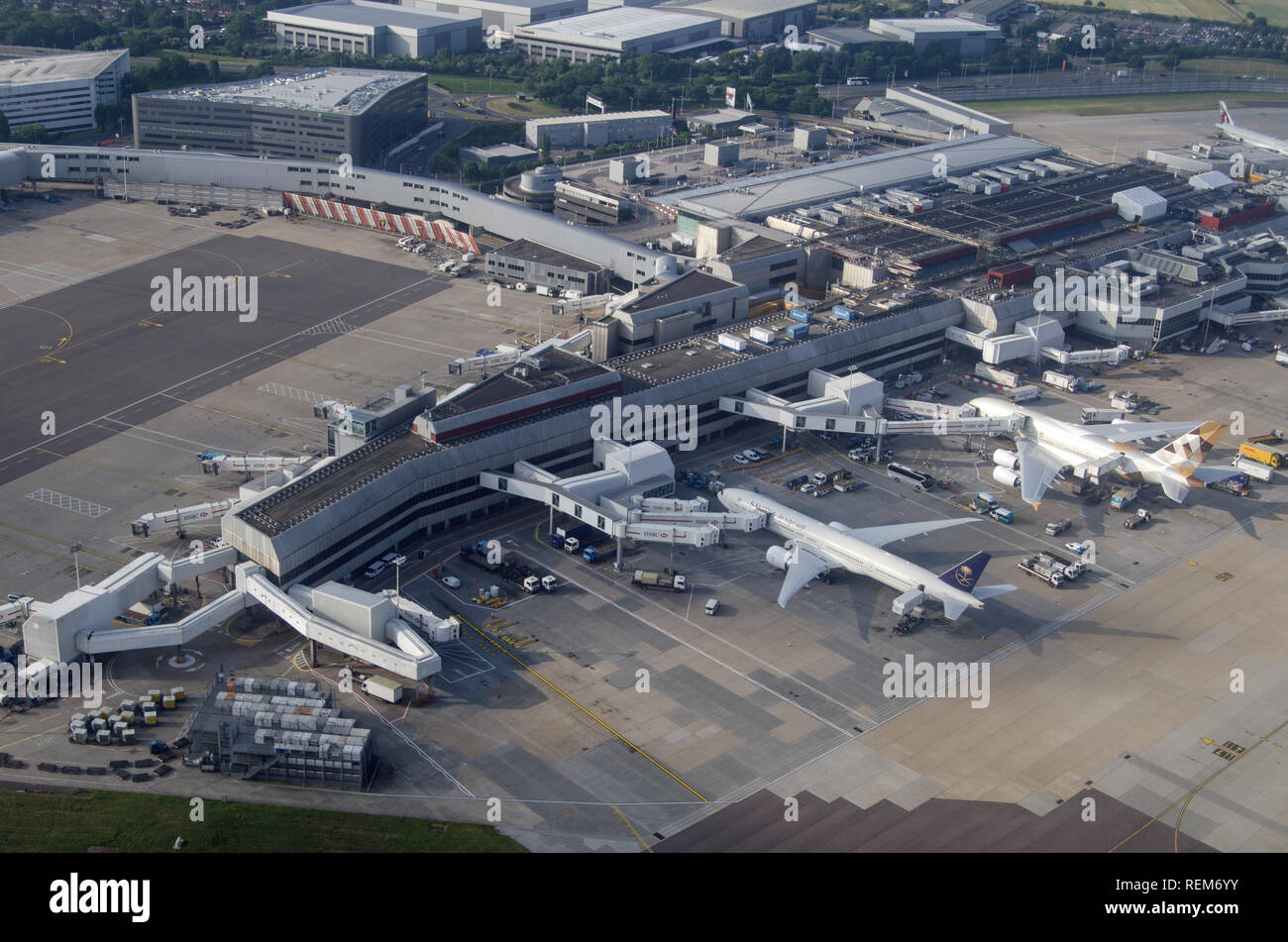 LONDON, UK - JUNE 12, 2018: Aerial view of planes from Saudia and Emirates Airline parked at Terminal 4 of London's Heathrow Airport on a sunny summer Stock Photo