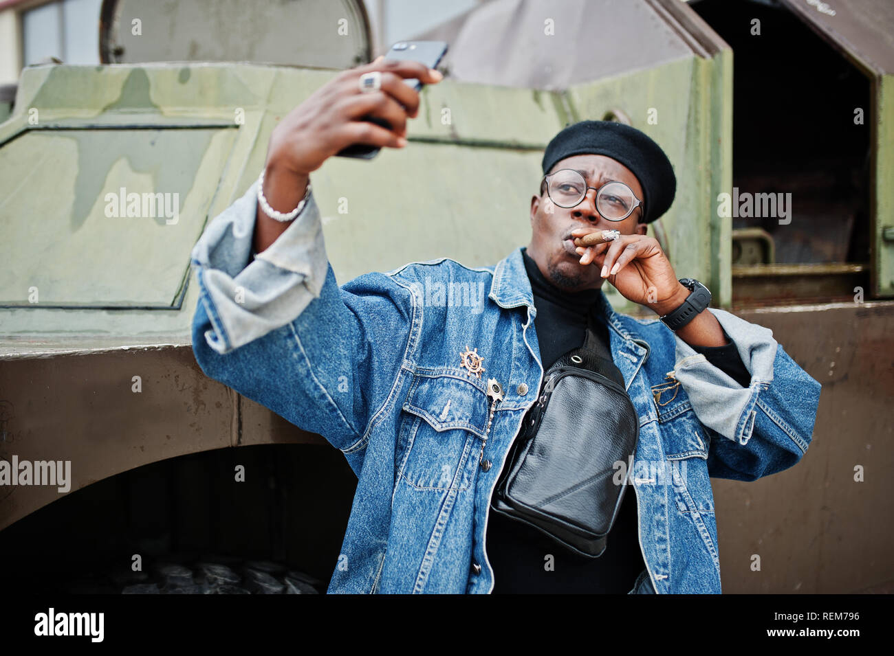 African american man in jeans jacket, beret and eyeglasses