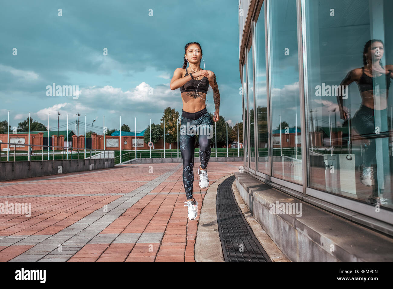 Free Photo  Sports girl training with phone and headphones