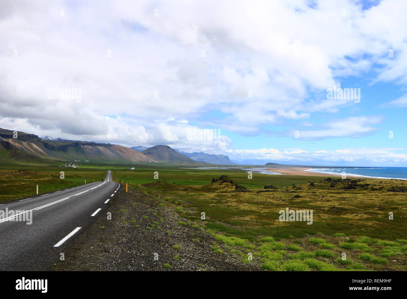Street in Iceland landscape with mountains, beach and lava Stock Photo