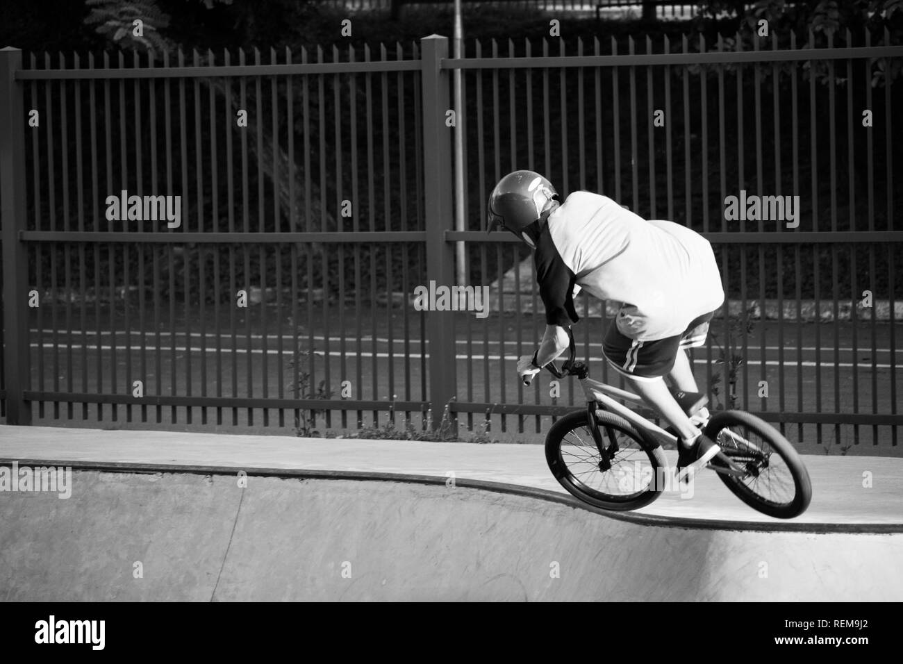 A boy riding a bike in a park. Stock Photo