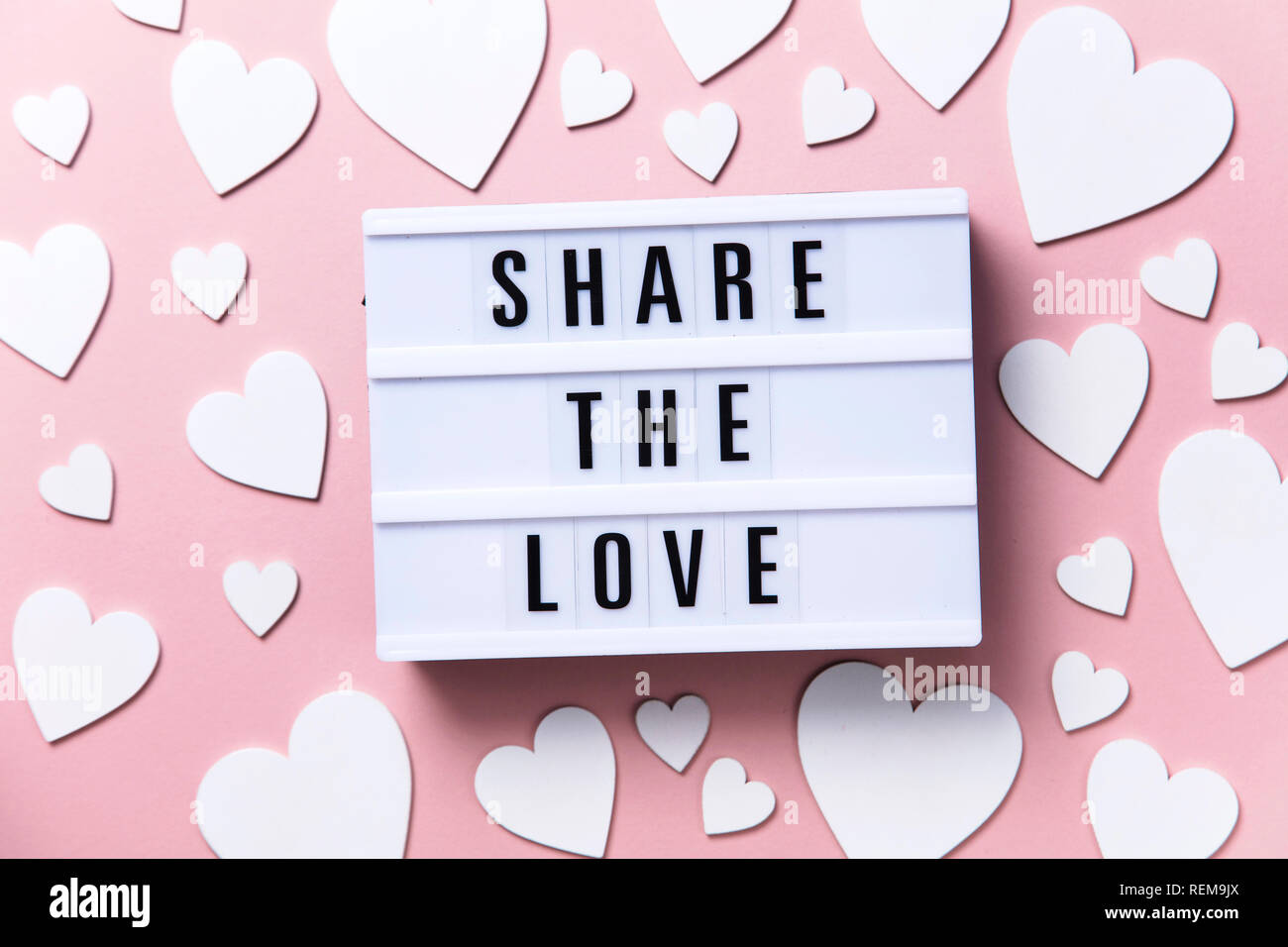 Share the Love lightbox message with white hearts on a pink background Stock Photo