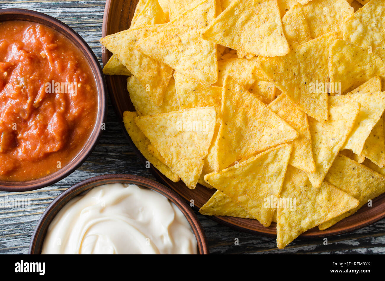 nachos corn chips with spicy tomato and cheese sauces mexican food concept yellow corn totopos chips with salsa sauce top view stock photo 232786839 alamy alamy