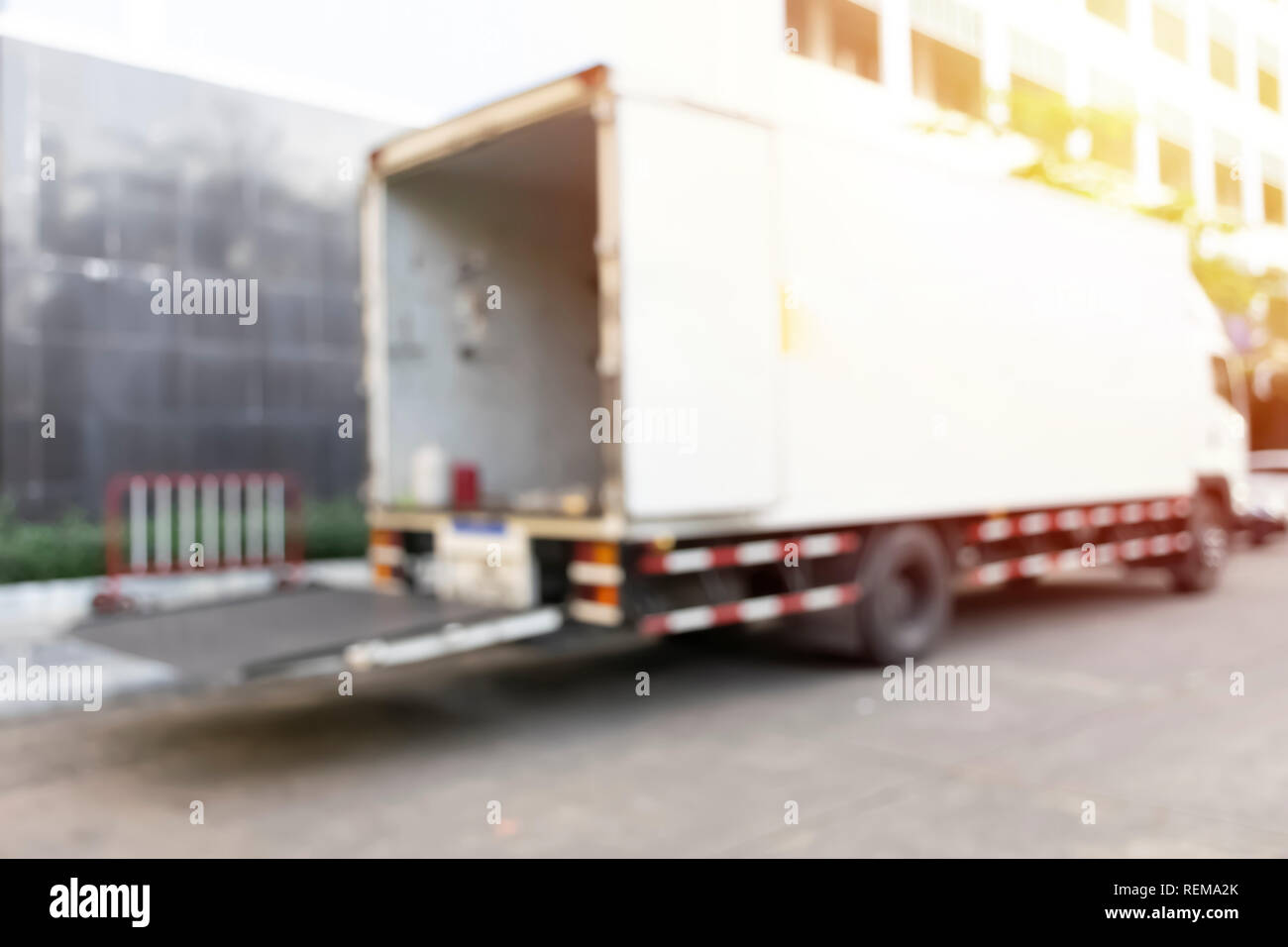Blurred modern trucks of involved for the transportation of different kinds of commercial. Loading and unloading. Stock Photo
