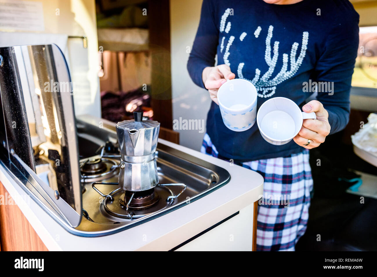 https://c8.alamy.com/comp/REMA6W/cooking-coffee-in-campervan-caravan-or-rv-on-camping-trip-woman-is-making-coffee-in-the-morning-using-italian-kafetiera-on-a-family-vacation-camping-REMA6W.jpg