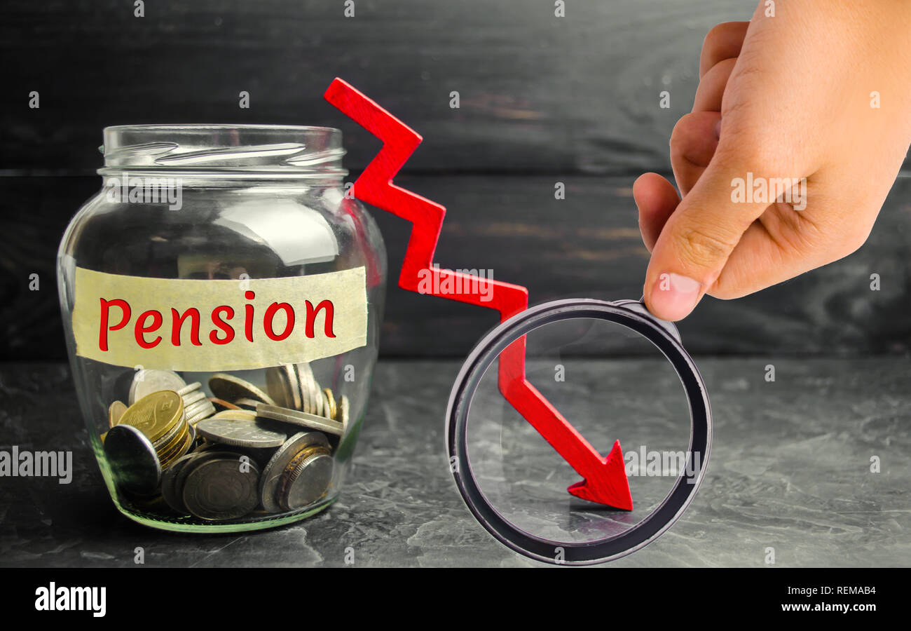 Glass jar with coins and the inscription 'Pension' and and down arrow. Decline / reduction pension payments. Retirement. Financing retirees Stock Photo