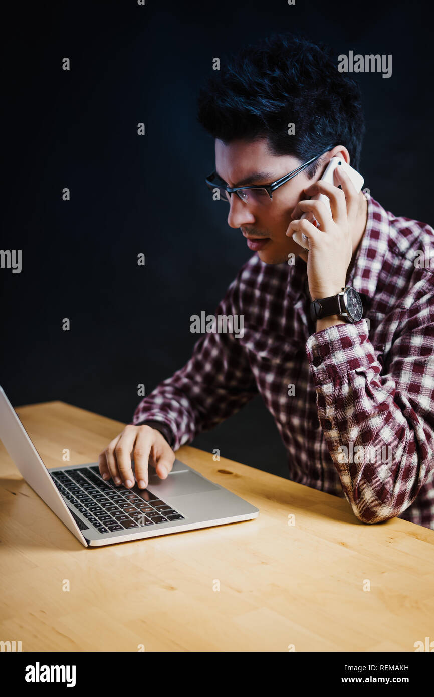 Programmer in the office working on the computer on a wooden desk Stock ...