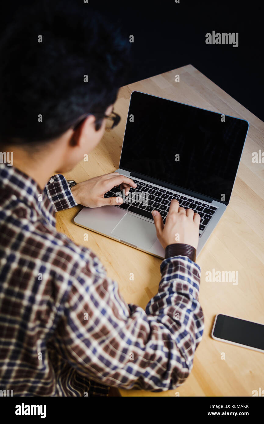 Programmer in the office working on the computer on a wooden desk Stock ...