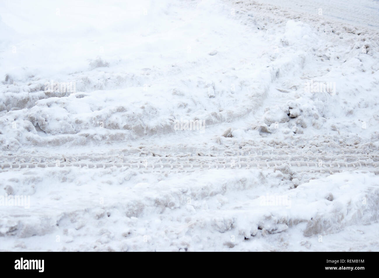 problem after snowfall - snow on the city road, snow porridge Stock Photo