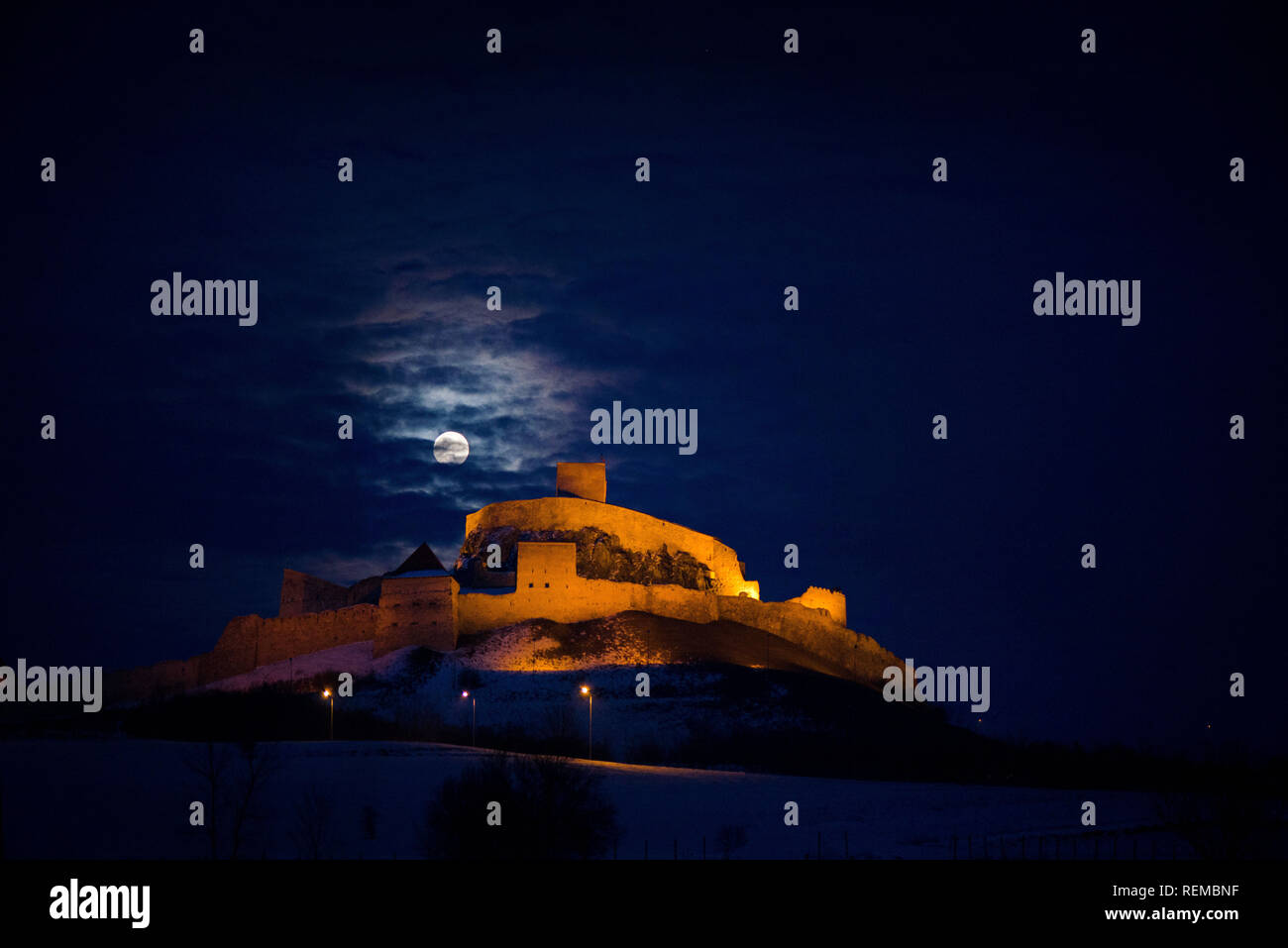 Dracula castle in the mountains in moonlight. Spooky palace in full
