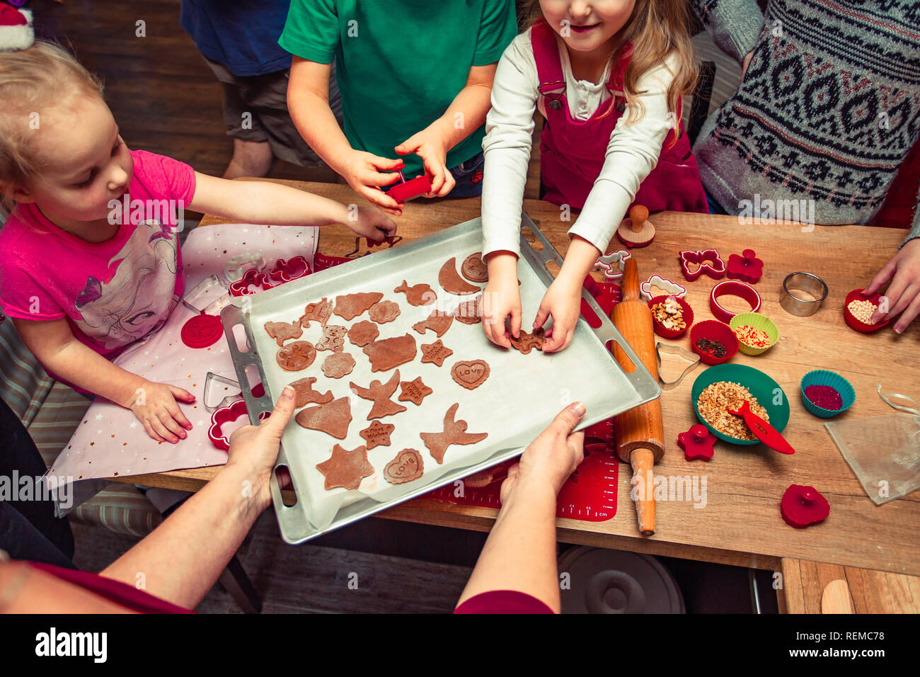 Baking Christmas cookies. Christmas gingerbread cookies in many shapes decorated with colorful frosting, sprinkle, icing, chocolate coating, toppers,  Stock Photo